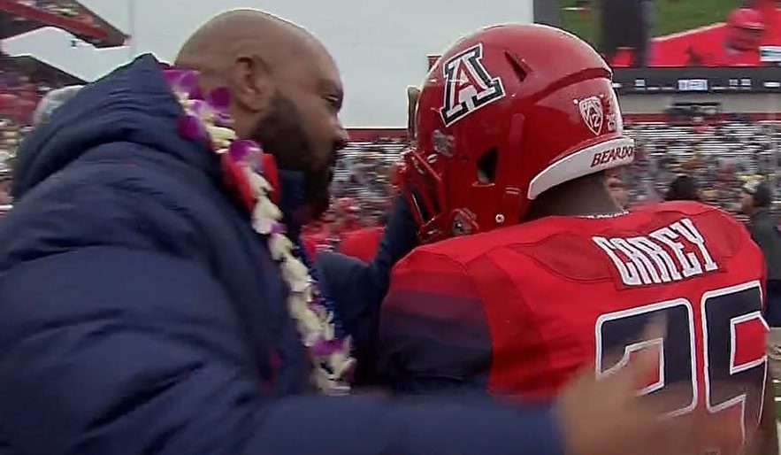 Ricky Hunley, left, congratulates and provides encouragement to Ka'Deem Carey after Carey's first touchdown run against Oregon two years ago (ABC-TV video capture)