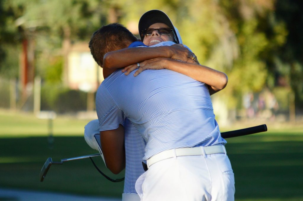 Gavin Cohen and Catalina Foothills head coach Julie Walters celebrate after Cohen clinched a n individual and team title (Andy Morales/AllSportsTucson.com)