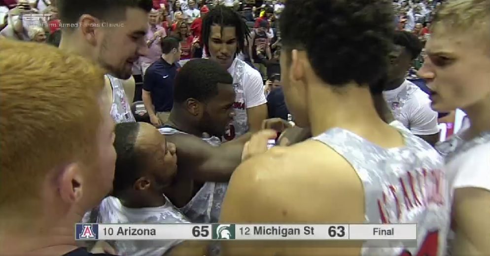 Kadeem Allen is mobbed by his teammates after leading Arizona to a victory over Michigan State on Friday night (ESPN screen shot)