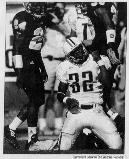 Arizona Republic clipping of Arizona running back Clarence Farmer celebrating during the Wildcats' 34-21 win over ASU in 2001